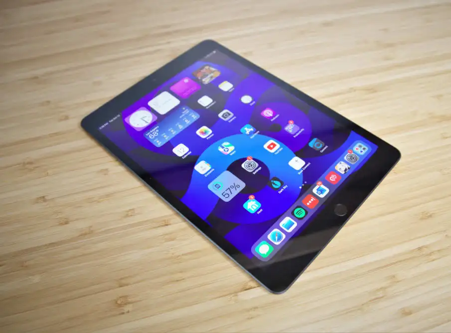 A computer tablet face up on a desk