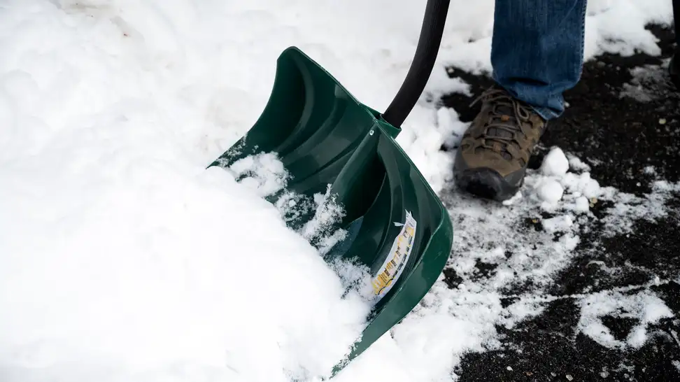Close-up of a shovel moving snow.