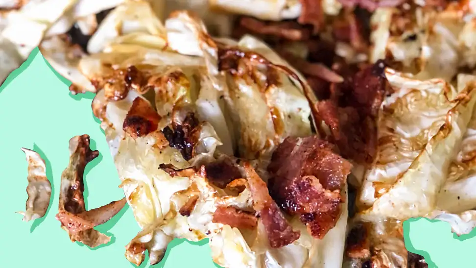 A close-up of grilled cabbage with crispy bacon.