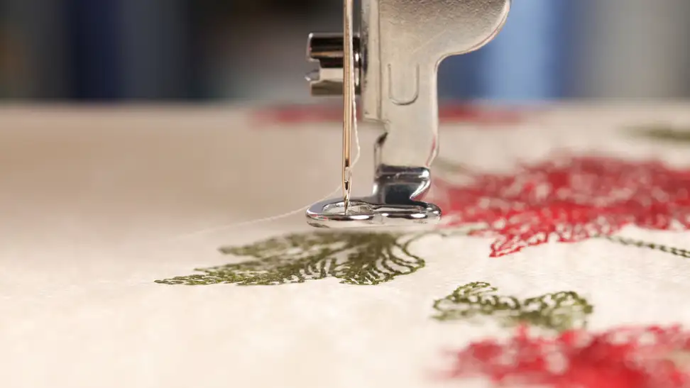 Embroidery machine embroidering cloth.