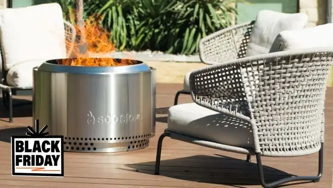 Chairs around a Solo Stove with a fire in it.