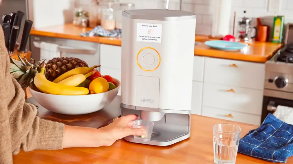 A person collects medication from a pill dispenser.