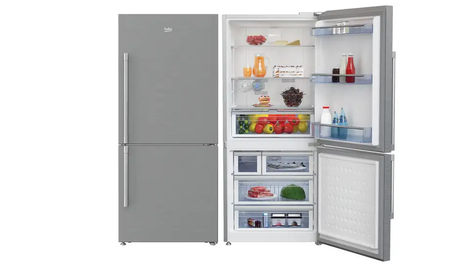 Two Beko fridges are side by side in a white void. The leftmost fridge has its door closed and the rightmost fridge has its door open, showcasing a wide array of food on its shelves and in its bins.