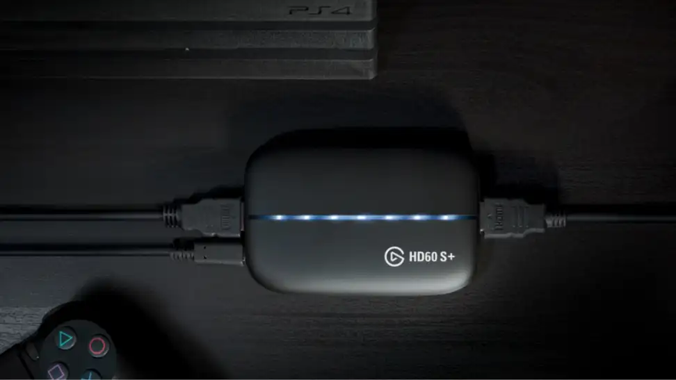 An image of an Elgato HD60 S+ capture card next to a PlayStation controller.