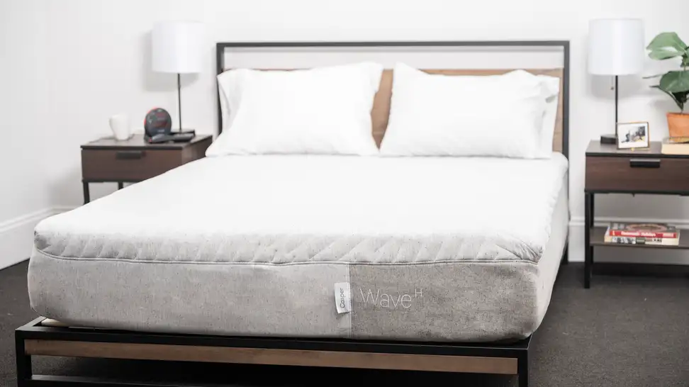 White mattress with pillows but without sheets.