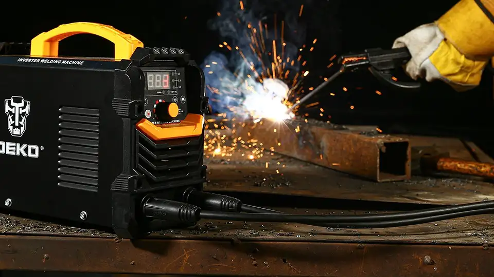 A Dekopro welder is in use. It's black and yellow.