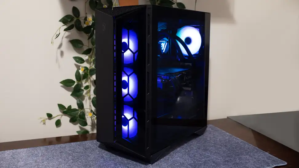 A glowing desktop tower sits next to a monitor