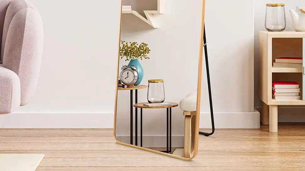 A Zbeivan floor mirror on display in a bedroom; an alarm clock appears in the reflection.