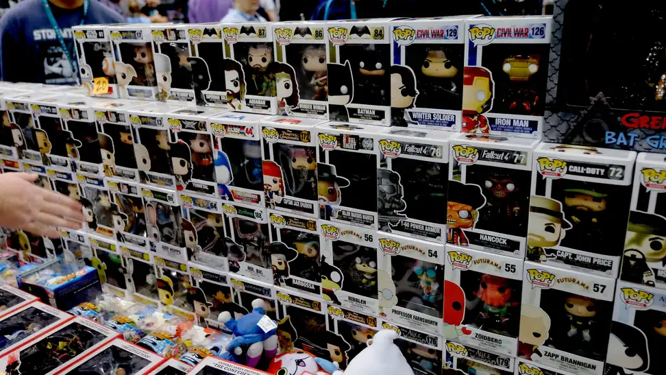 A collection of sealed Funko Pops sitting on a department store shelf.
