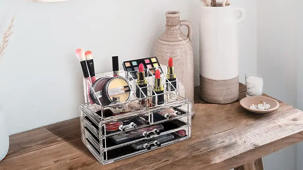 A clear makeup organizer holding brushes, palettes, lipsticks, and more.