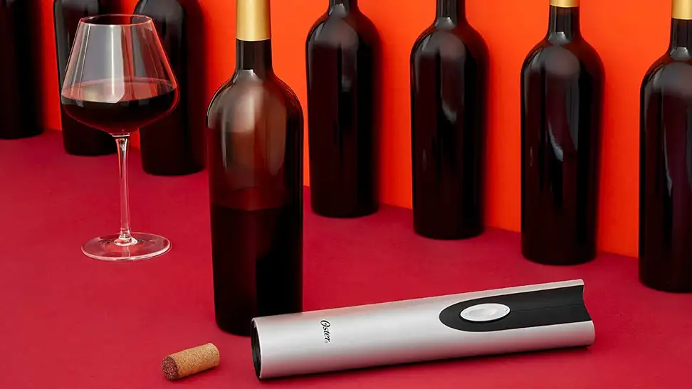 An electric wine bottle opener being used to open wine bottles.