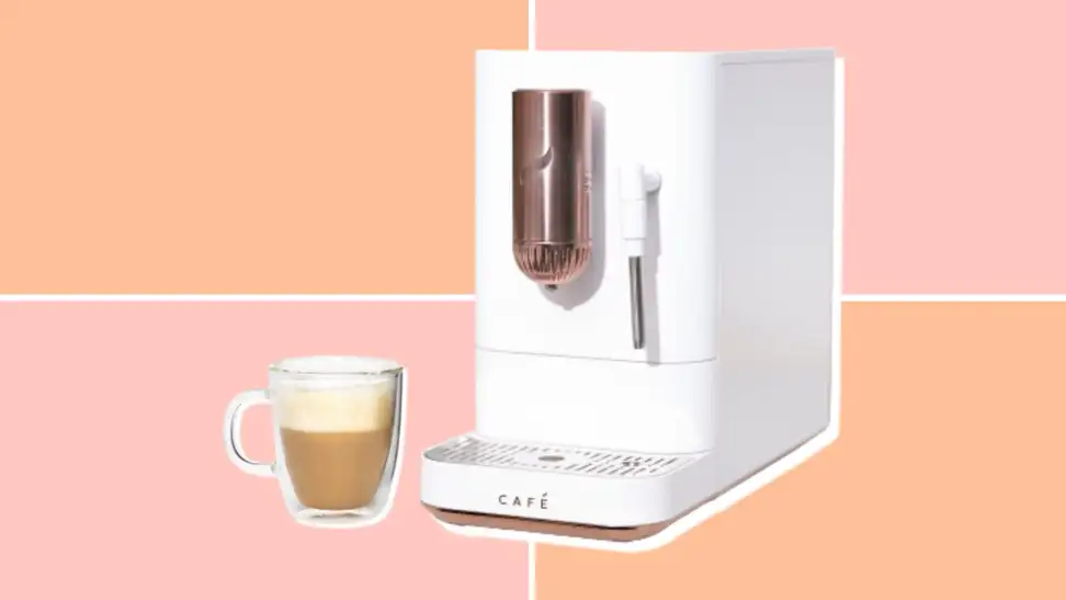 Café Affetto machine next to a latte in a glass mug, on a pink and orange backgorund.