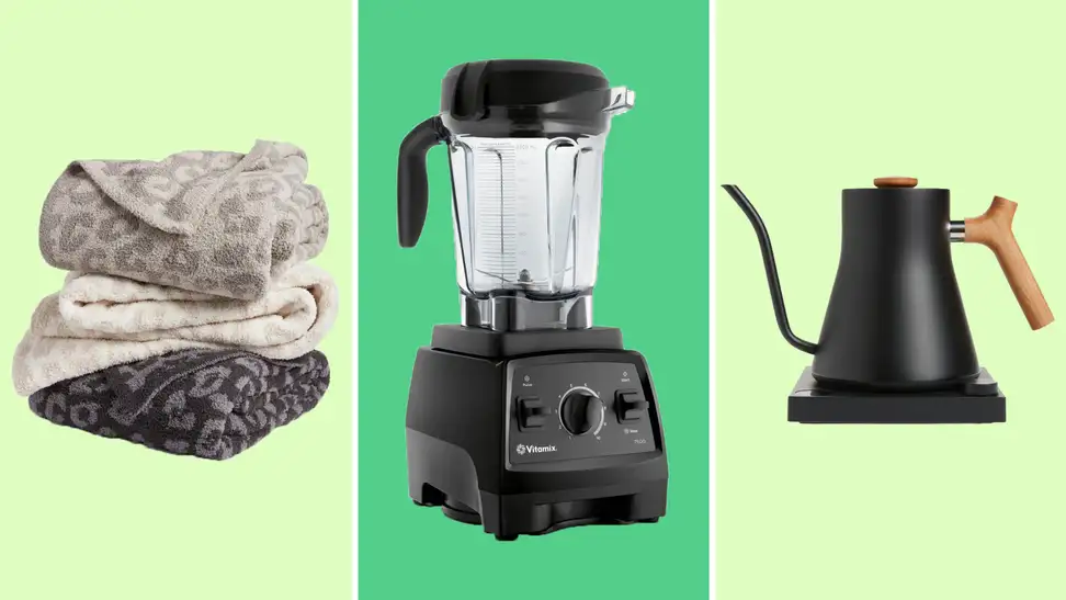 A collection of towels stacked on each other against a light green background on the left. A VitaMix blender against a green background in the middle. A kettle against a light green background on the right.