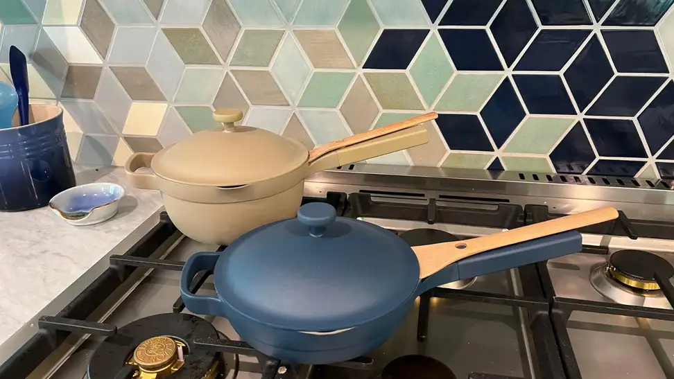 Mini Always Pan and Mini Perfect Pot, covered on top of a gas range.