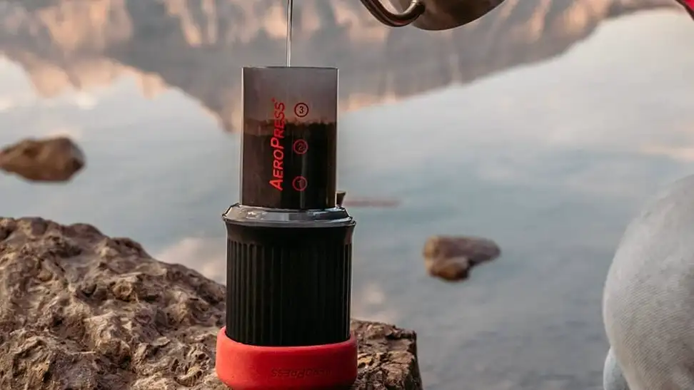 A portable coffee maker being used on a camping trip.