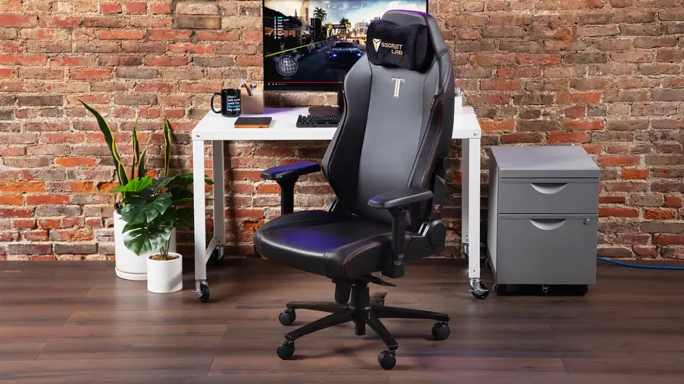 The SecretLab gaming chair in our labs in front of a desktop.