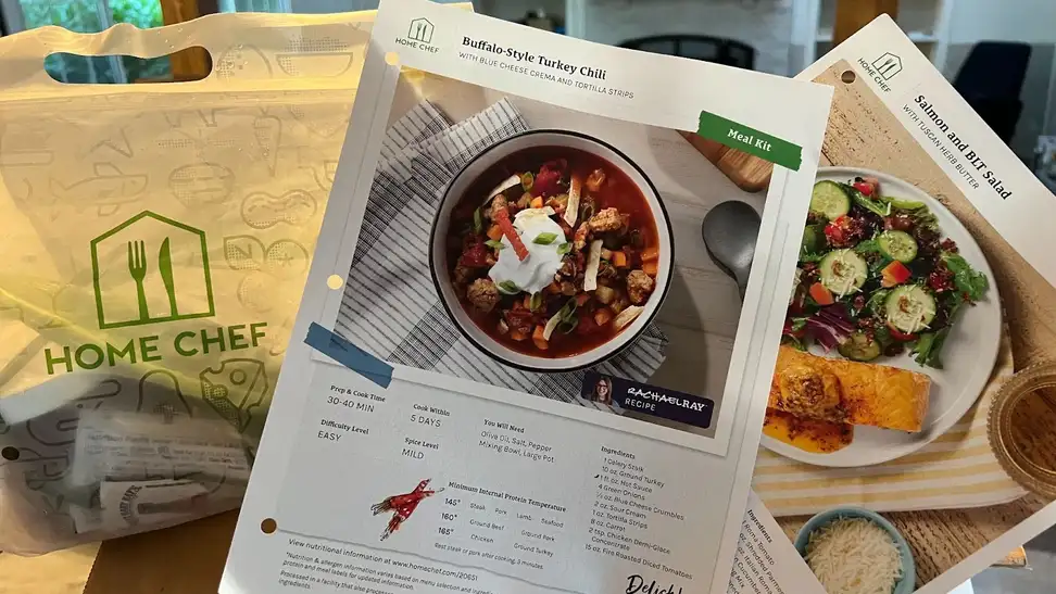 Paper with recipe instructions for Buffalo-Style Turkey Chili next to bag of food ingredients and recipe instructions for Salmon and BLT salad.
