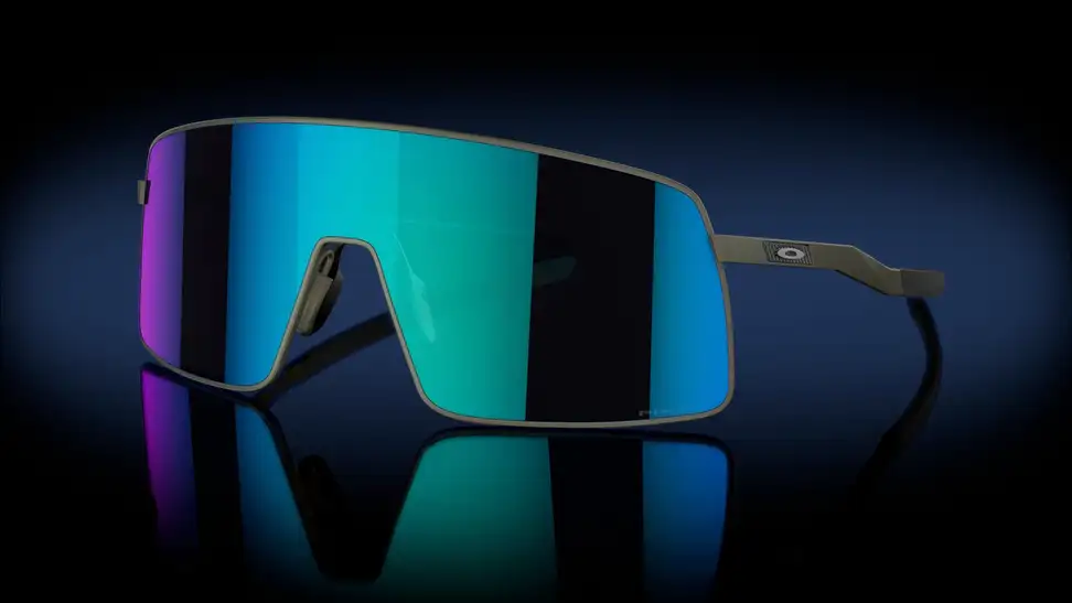 A pair of wide, blue-and-violet-tinted oversized Oakleys against a black backdrop.