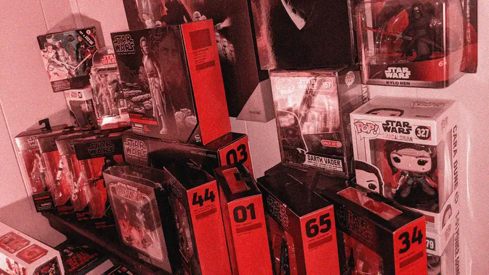 A large collection of Star Wars toys from Hasbro and Funko, most of them in black-and-red Black Series packaging.