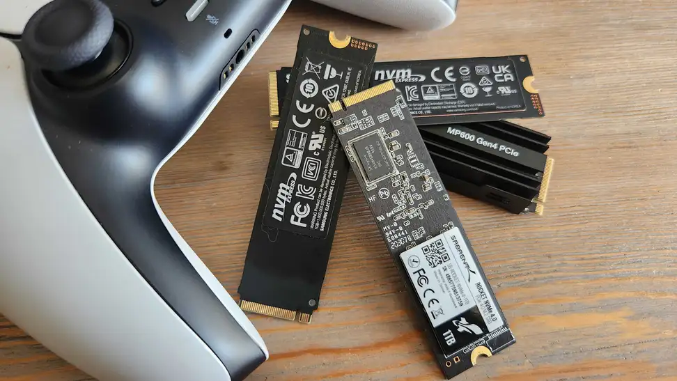 A collection of M.2 SSDs next to a gaming controller