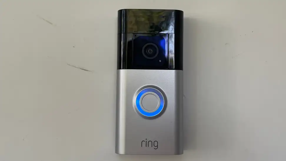 Ring Battery Doorbell Plus hanging on a front door