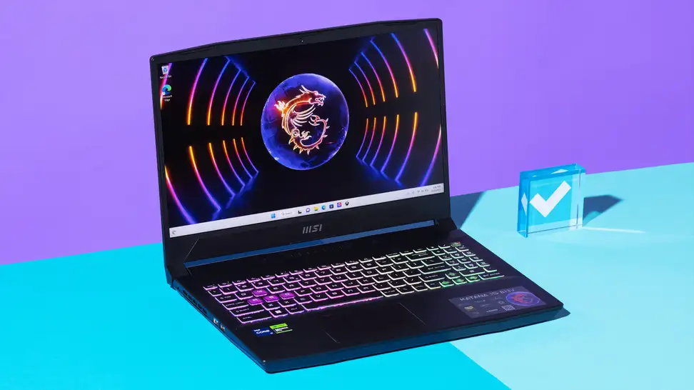 An open and powered on black laptop with a neon-lit keyboard against a purple and blue backdrop.