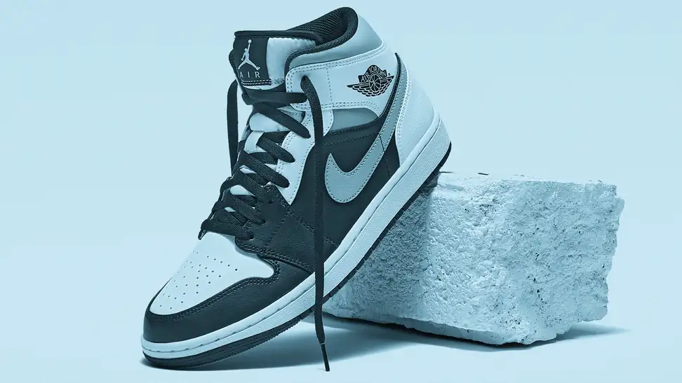 A Nike Air Jordan sneaker is displayed in close-up while resting against a brick.