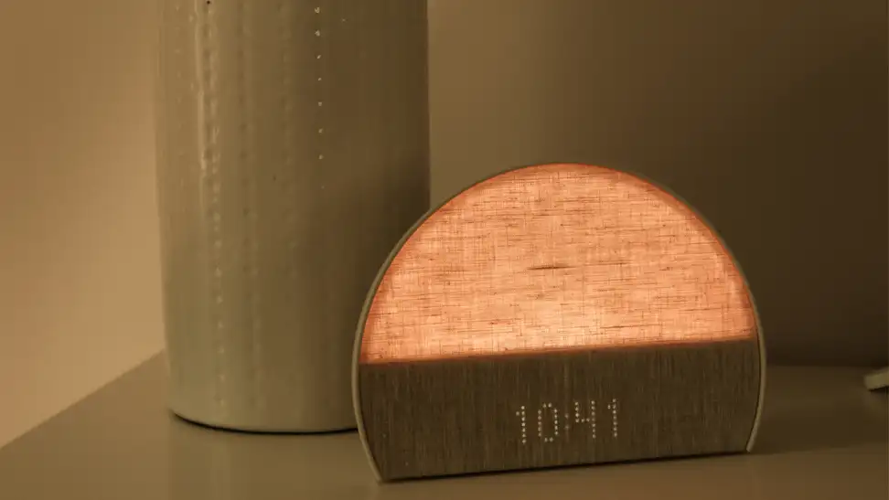 A smart bedside lamp, the glowing orange-tinted Hatch Restore 2, sits on a nightstand. The time reads 10:41.