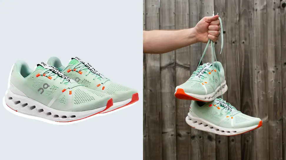 Green sneakers against a blue background, and also being held up by its laces on the right.