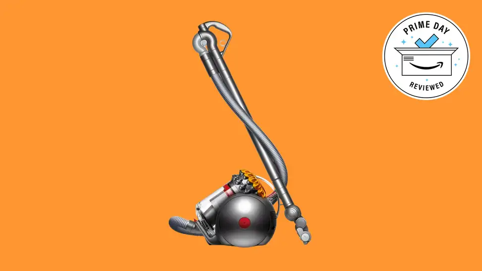 A side view of the Dyson Big Ball canister vacuum floating in an orange void.