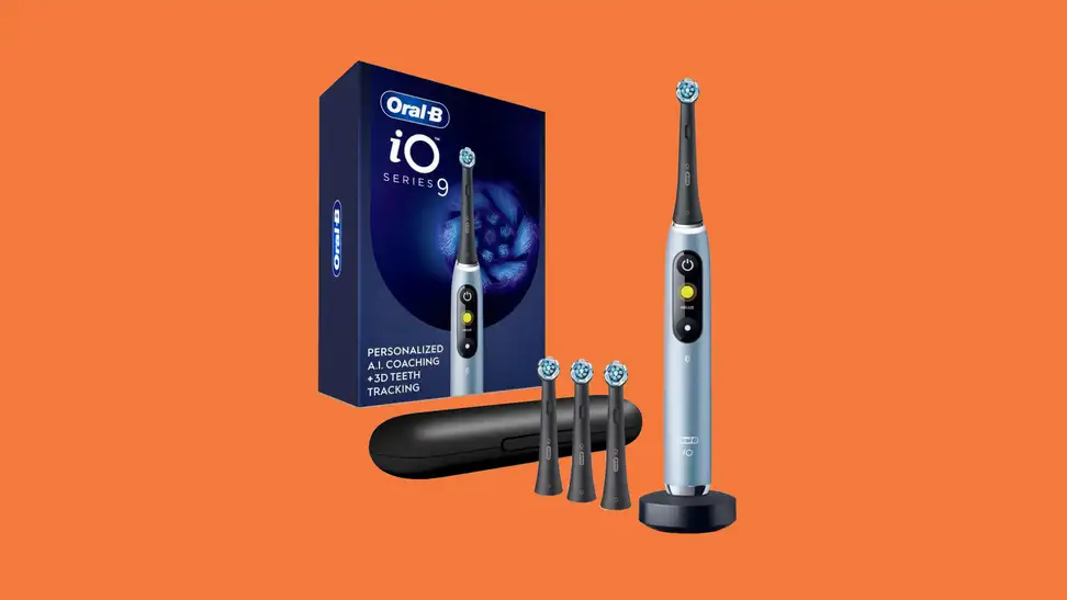 An Oral-B electric toothbrush with four brush heads, a case, and its packaging on an orange background,