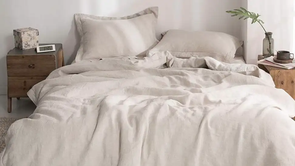 A duvet cover laying over a bed in a bedroom.