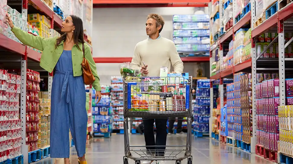 A couple shopping for things at Sam's Club.