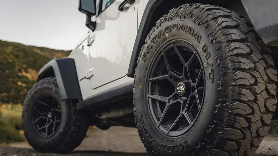 A set of black rims on a Jeep Wrangler.