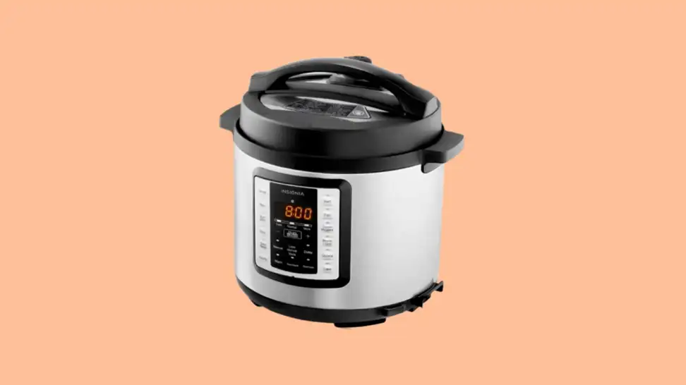Insignia pressure cooker against peach background