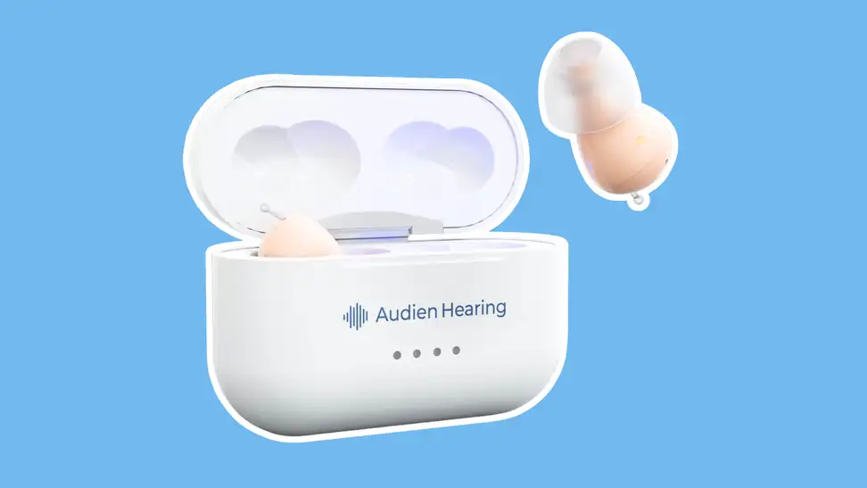 The Audien Atom 2 hearing aids in a white case on a blue background.