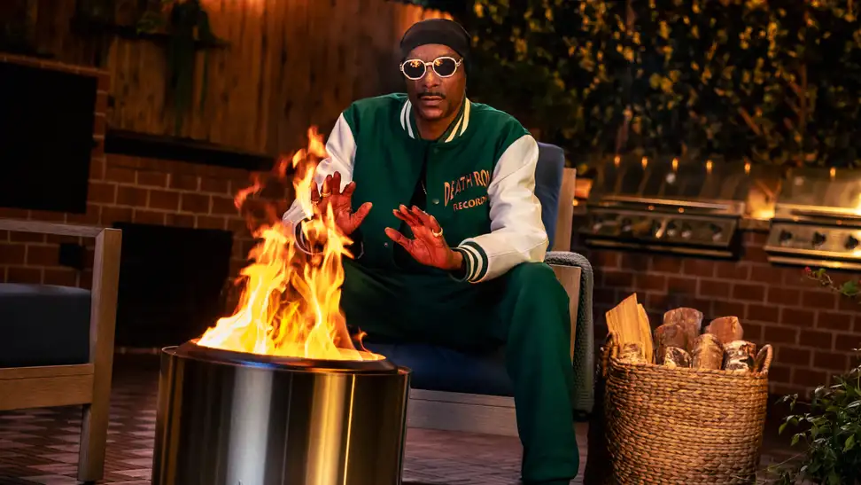 Snoop Dogg sitting next to Bonfire Solo Stove firepit