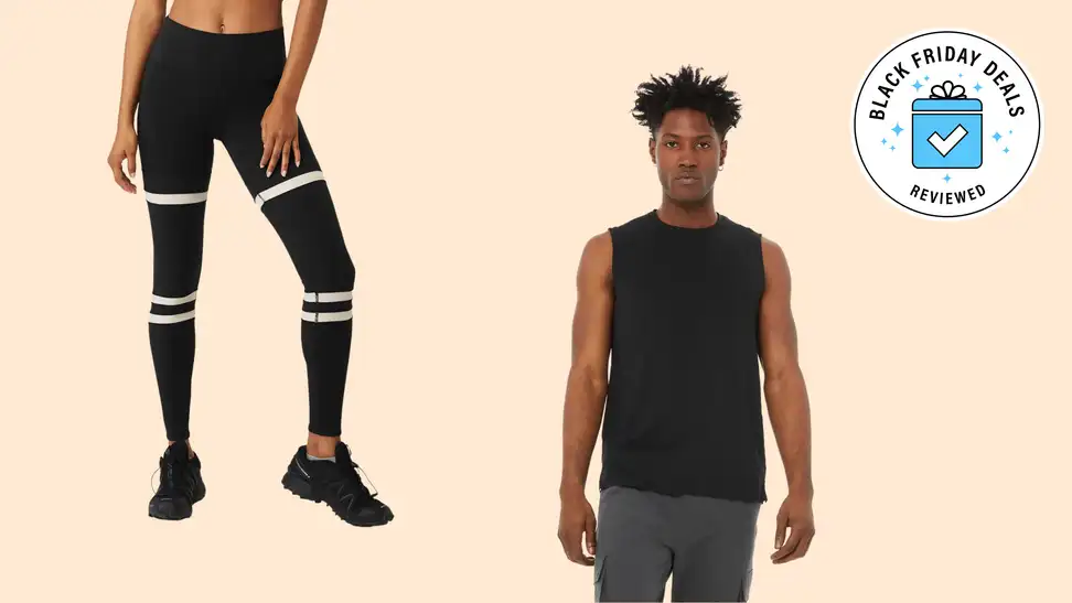 A pair of leggings and tank top on a beige background.