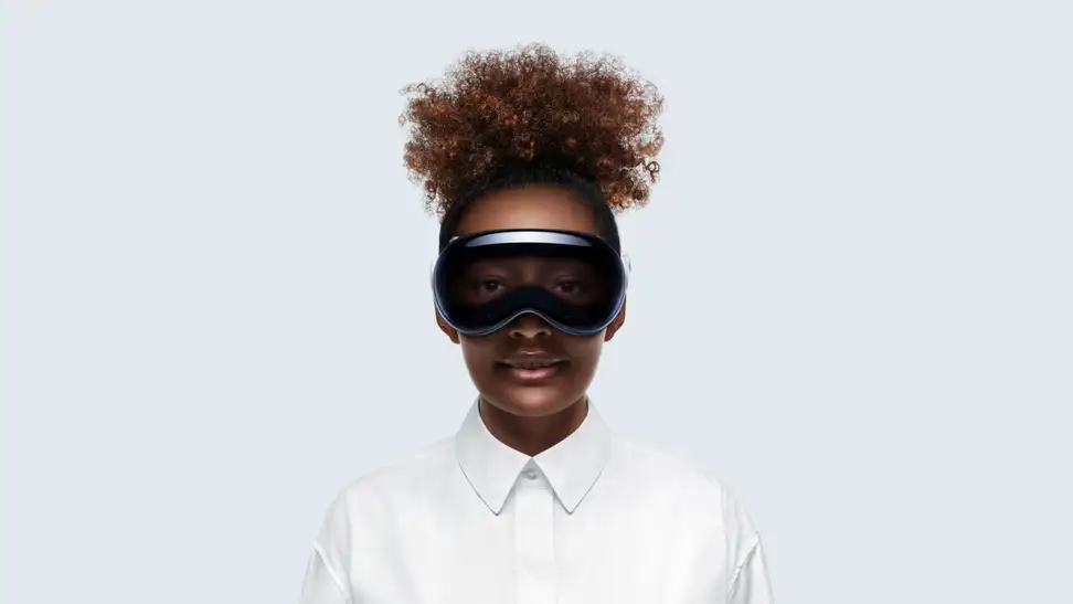 A person in a white button-down shirt sports the black-colored Apple Vision Pro.