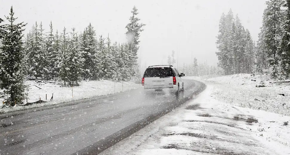 A car being driven in the winter.