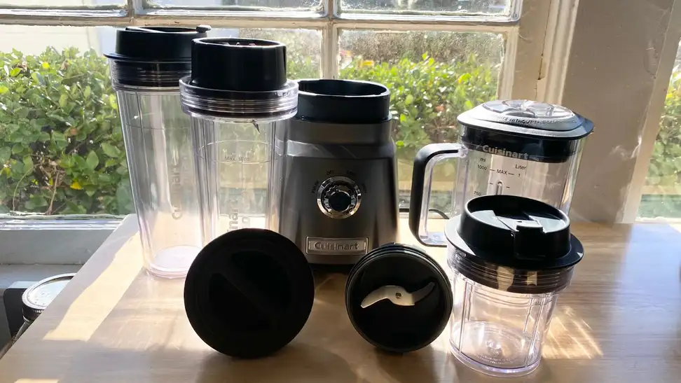 Cuisinart Hurricane Compact Juicing Blender deconstructed with blades, travel jugs and lids.