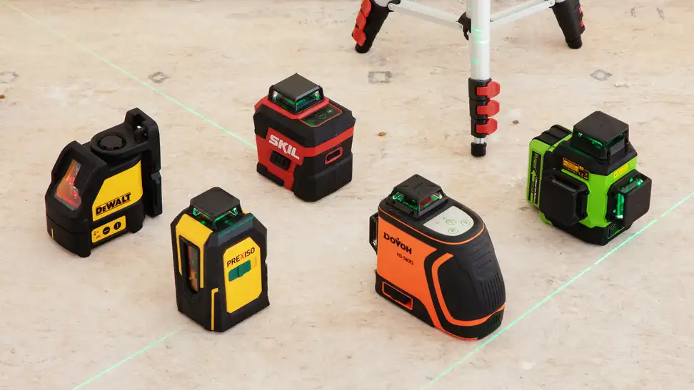 Five laser levels sit on a light color floor