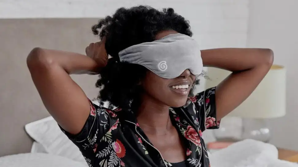 Person with weighted eye mask over eyes.