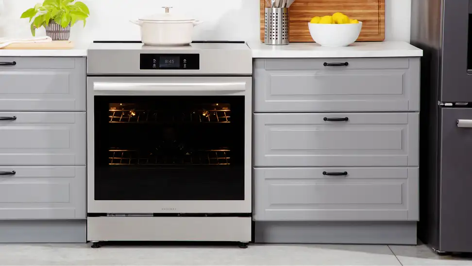 Frigidaire Gallery GCFI3060BF 30-inch Induction Range in between two drawers in modern kitchen setting.