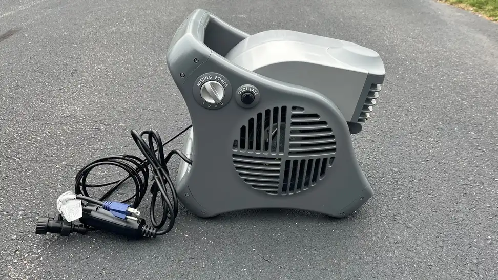 Side view of the Lasko Misto showing the misting power dial and the oscillate button.
