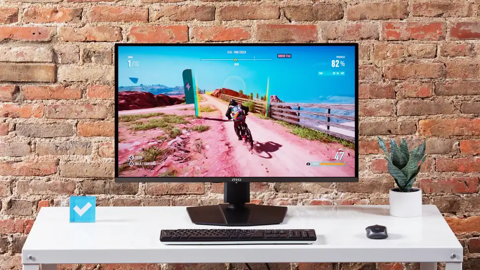 The MSI MPG 321URX gaming monitor on a white desktop.