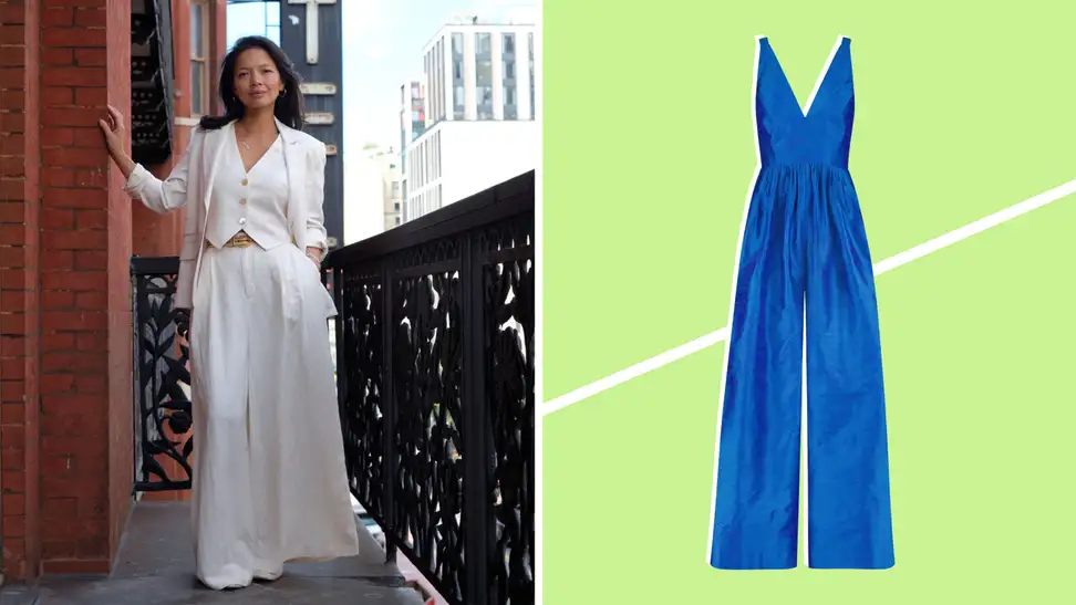 A woman on a balcony wearing a white linen suit with oversized pants and a matching vest, also a silk jumpsuit.