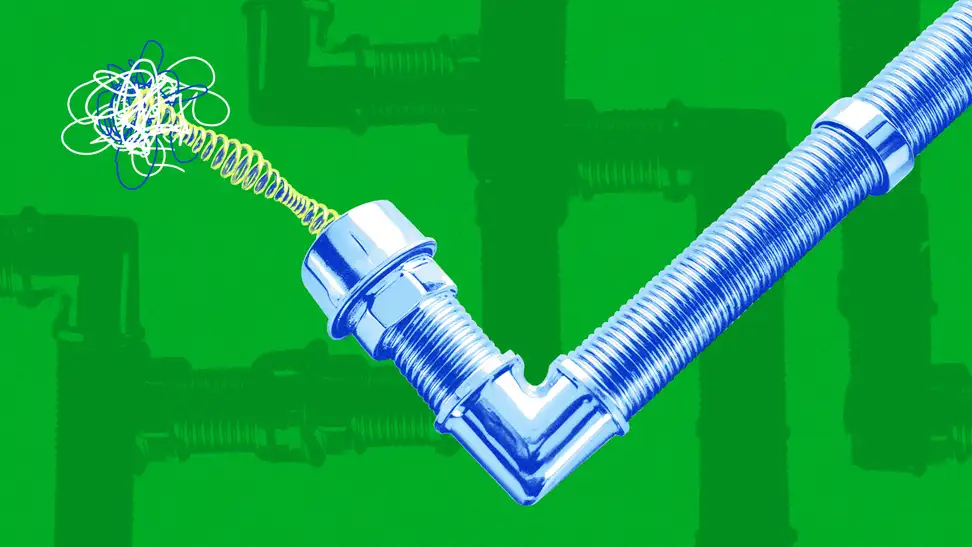 A cartoon image of a blue drain pipe with a clog coming out of one end.