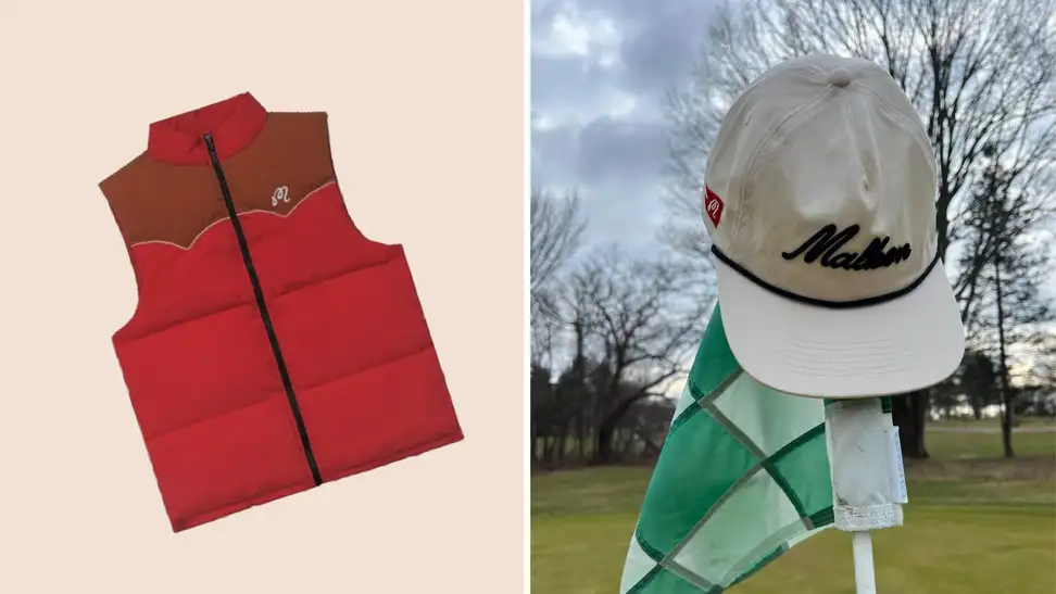A red puffy vest and a white Malbon golf hat atop a golf flagstick.