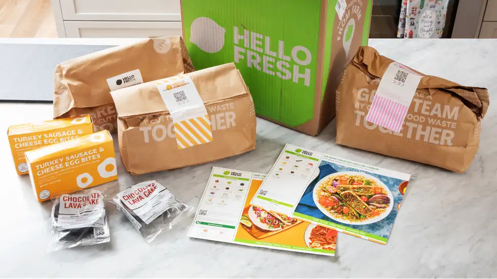 A number of meal kits spread out atop a table.